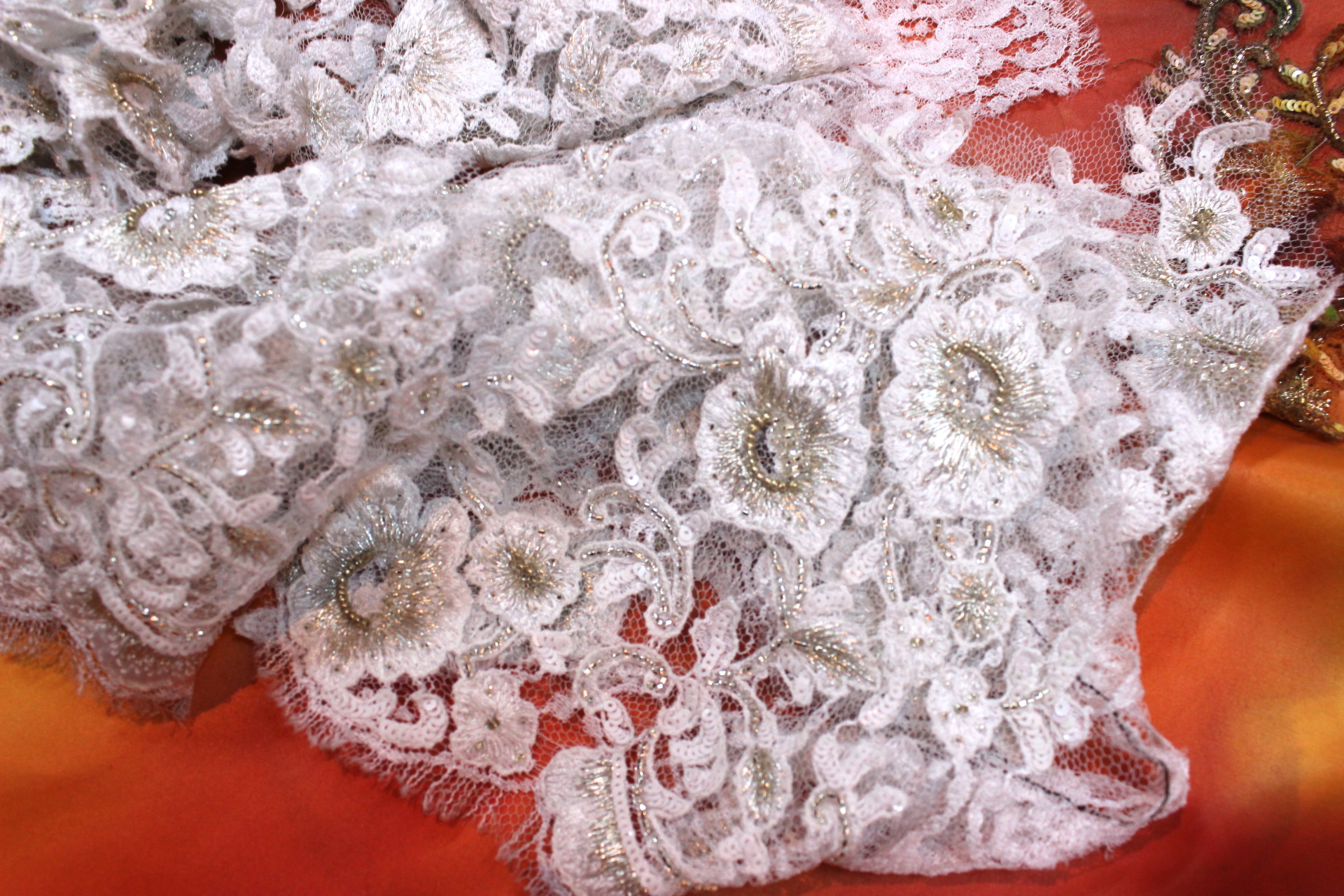 Imagine that this lace arrives from France plain and then hand embroidered with biser and finally hand painted to make decorations for the dresses. 